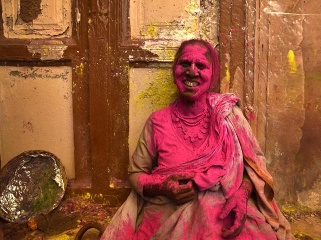A widow smeared in Gulal takes part in Holi celebrations at Gopinath temple.The widows were highly excited as first time they played Holi inside any temple, marking their further social assimilation. (Ajay Aggarwal/HT Photo)