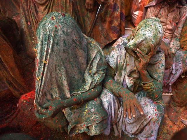 Widows smeared in Gulal rest after taking part in Holi celebrations at Vrindavan. It is for the first time Holi celebration was organised at an ancient Gopinath Temple of Lord Krishna in which around a thousand widows from Vrindavan and Varanasi splashed colour at each other. (Ajay Aggarwal/HT Photo)