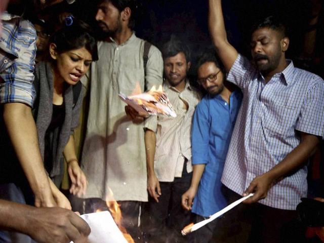 Former ABVP members who left the RSS' student outfit citing differences over its handling of the JNU row, burn a copy of the Manusmriti, in New Delhi. (PTI File Photo) Former ABVP members who left the RSS' student outfit citing differences over its handling of the JNU row, burn a copy of the Manusmriti, in New Delhi. (PTI File Photo)