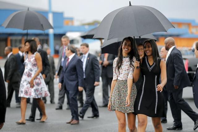 US President Barack Obama's daughters Malia (centre) and Sasha (right) arrive with their parents at the Jose Marti international airport. (Reuters Photo) US President Barack Obama's daughters Malia (centre) and Sasha (right) arrive with their parents at the Jose Marti international airport. (Reuters Photo)