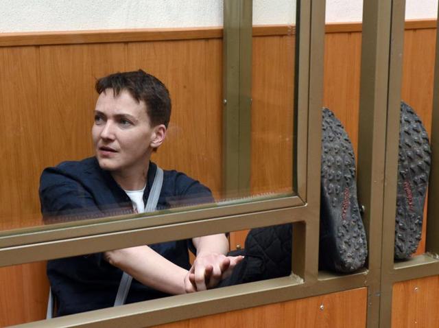Ukrainian military pilot Nadiya Savchenko sits inside a defendant's cage during her sentencing hearing at a court in the southern Russian town of Donetsk. (AFP) Ukrainian military pilot Nadiya Savchenko sits inside a defendant's cage during her sentencing hearing at a court in the southern Russian town of Donetsk. (AFP)