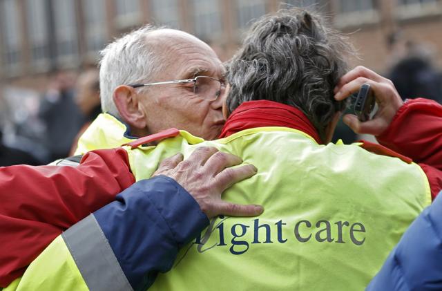 Airport workers embrace as they leave the scene of the explosions at Zaventem airport near Brussels. (REUTERS) Airport workers embrace as they leave the scene of the explosions at Zaventem airport near Brussels. (REUTERS)