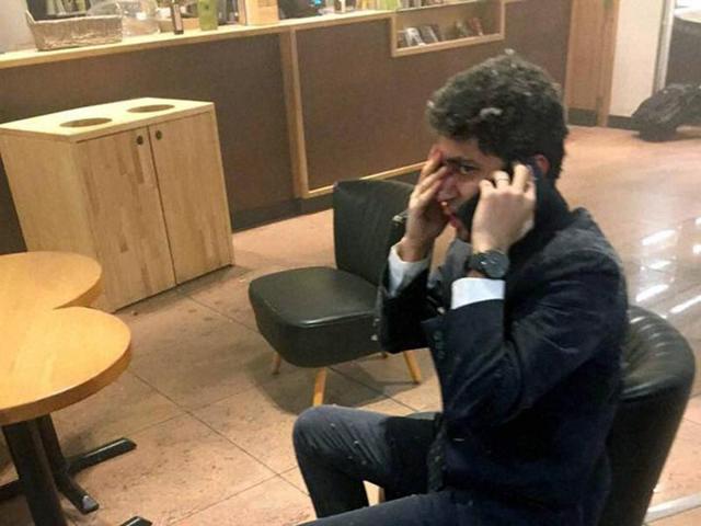 In this photo provided by Georgian Public Broadcaster and photographed by Ketevan Kardava a man speaks on a mobile phone in Brussels Airport in Brussels, Belgium, after explosions were heard. (AP) In this photo provided by Georgian Public Broadcaster and photographed by Ketevan Kardava a man speaks on a mobile phone in Brussels Airport in Brussels, Belgium, after explosions were heard. (AP)