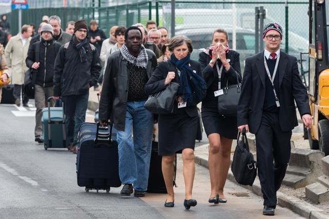People walk away from Brussels airport. (AP Photo) People walk away from Brussels airport. (AP Photo)