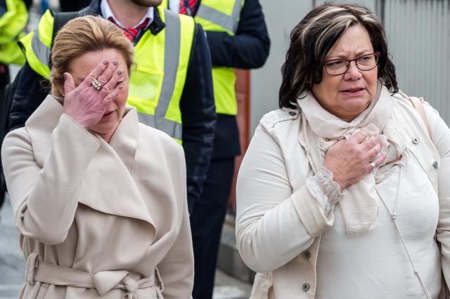 People react as they walk away from the Brussels airport after the explosions. Explosions ripped through the airport and the subway system on Tuesday. (AP) People react as they walk away from the Brussels airport after the explosions. Explosions ripped through the airport and the subway system on Tuesday. (AP)