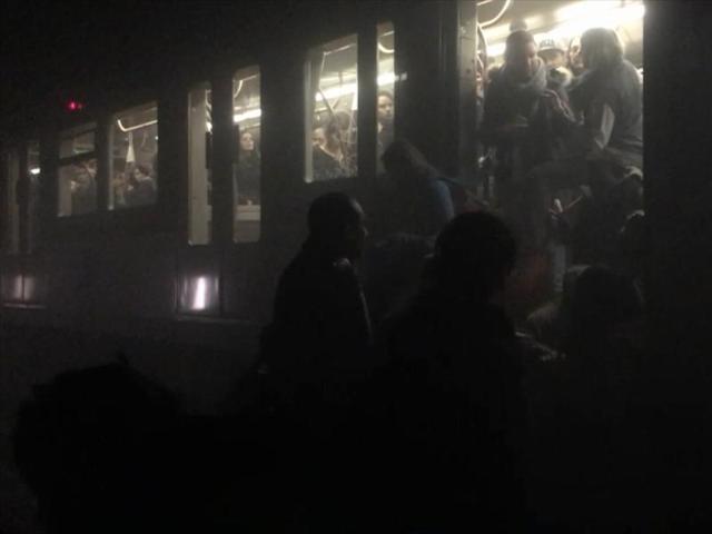In this photo provided by Evan Lamos passengers clamber from a metro carriage after explosions in Brussels Tuesday. (AP) In this photo provided by Evan Lamos passengers clamber from a metro carriage after explosions in Brussels Tuesday. (AP)