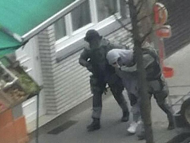 An unidentified man believed to be connected to key suspect in the November 2015 Paris attacks Salah Abdeslam, is detained by police during a raid in the Molenbeek neighborhood of Brussels, Belgium. (AP Photo) An unidentified man believed to be connected to key suspect in the November 2015 Paris attacks Salah Abdeslam, is detained by police during a raid in the Molenbeek neighborhood of Brussels, Belgium. (AP Photo)