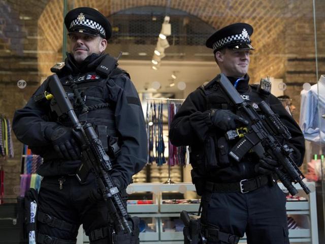 Armed British police officers stand guard after Eurostar services were suspended on the Brussels route. (AP Photo) Armed British police officers stand guard after Eurostar services were suspended on the Brussels route. (AP Photo)
