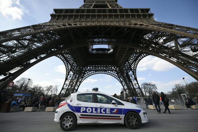 A police car is deployed near the Eiffel tower in Paris on Tuesday. Paris said it will light the tower in the colours of the Belgian flag in the evening as an act of solidarity. (AFP) A police car is deployed near the Eiffel tower in Paris on Tuesday. Paris said it will light the tower in the colours of the Belgian flag in the evening as an act of solidarity. (AFP)