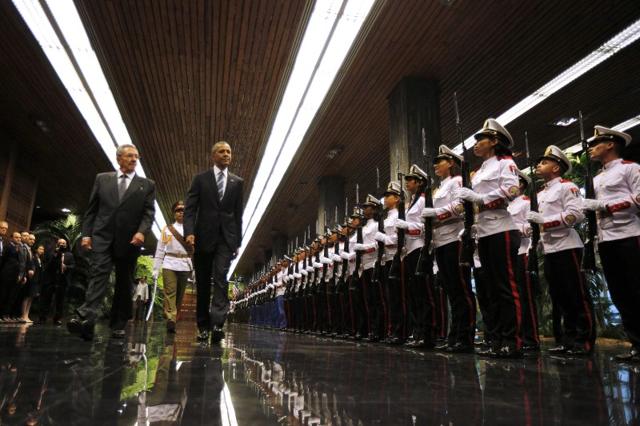 US President Barack Obama and Cuba's President Raul Castro walk past honour guards during their first meeting in Havana March 21, 2016. (REUTERS) US President Barack Obama and Cuba's President Raul Castro walk past honour guards during their first meeting in Havana March 21, 2016. (REUTERS)