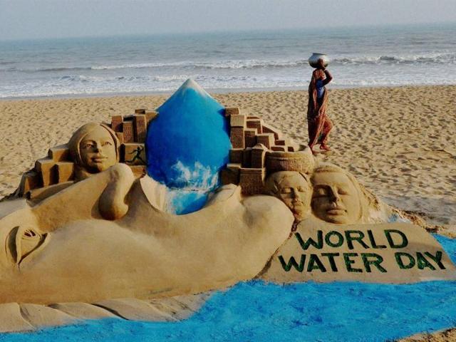 A woman carries water pot past sand sculpture of artist Manash Sahoo on the eve of World Water Day on Puri beach.(PTI) A woman carries water pot past sand sculpture of artist Manash Sahoo on the eve of World Water Day on Puri beach.(PTI)