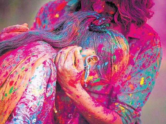 A girl gets smeared with colour during Holi celebrations.(iStock)