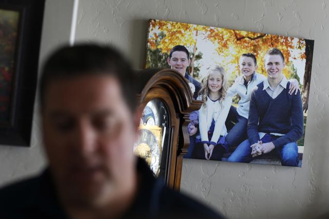 A picture of Mason Wells, on the right on the photo hanging on the wall, is on display as Mason Wells' father Chad Wells talks about him. (AP) A picture of Mason Wells, on the right on the photo hanging on the wall, is on display as Mason Wells' father Chad Wells talks about him. (AP)