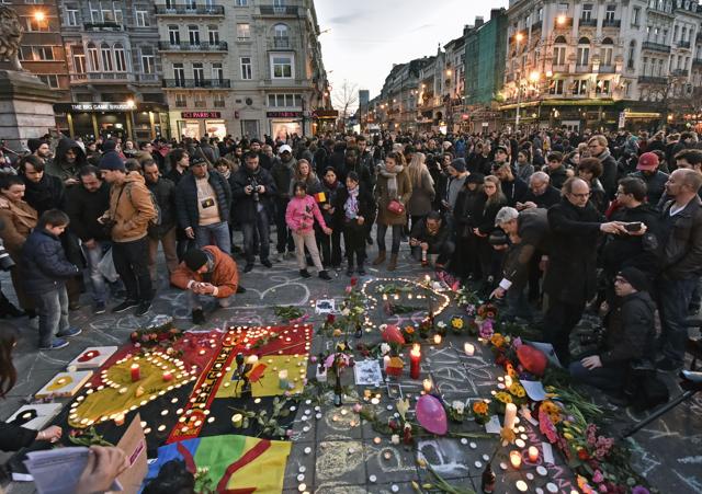People bring flowers and candles to mourn at the Place de la Bourse in the center of Brussels. (AP) People bring flowers and candles to mourn at the Place de la Bourse in the center of Brussels. (AP)