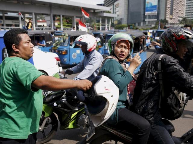 A taxi is attacked for not taking part in protest by taxi drivers who are demanding that the government ban ride-hailing apps in Jakarta. (REUTERS) A taxi is attacked for not taking part in protest by taxi drivers who are demanding that the government ban ride-hailing apps in Jakarta. (REUTERS)