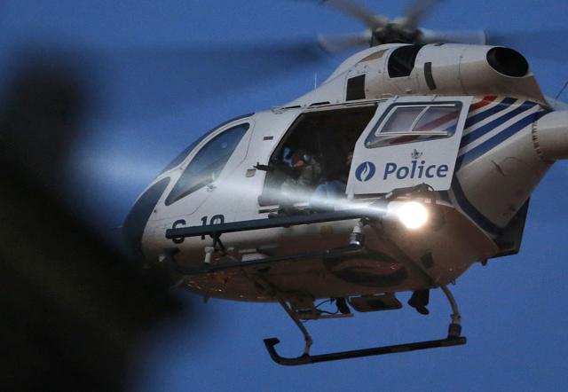A police sharpshooter takes aim from a helicopter hovering over Brussels' rooftops. (REUTERS) A police sharpshooter takes aim from a helicopter hovering over Brussels' rooftops. (REUTERS)