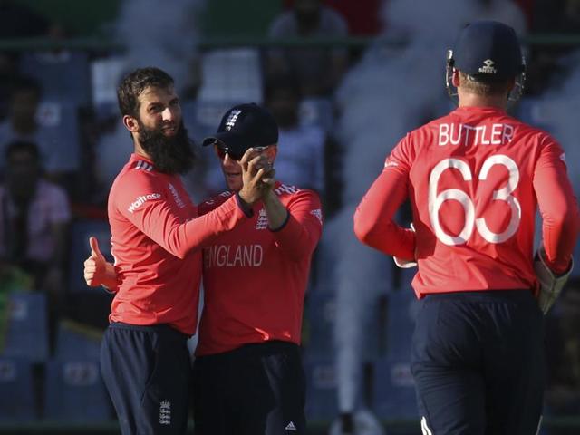 England's Moeen Ali, left, and Eoin Morgan, center, celebrate the fall of an Afghan wicket while playing against Afghanistan during the World T20 match at the Feroz Shah Kotla stadium in New Delhi on March 23, 2016. (AP) England's Moeen Ali, left, and Eoin Morgan, center, celebrate the fall of an Afghan wicket while playing against Afghanistan during the World T20 match at the Feroz Shah Kotla stadium in New Delhi on March 23, 2016. (AP)