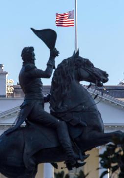 The US flag is seen flying at half-staff over the White House, behind the equestrian statue of Andrew Jackson after US President Barack Obama ordered the lowering in honour of the victims of the attacks in Brussels. (AFP)