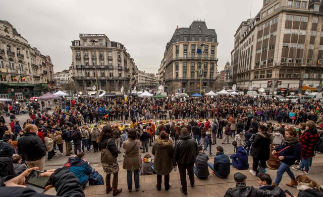 Belgians gather at a makeshift memorial at Place de la Bourse (Beursplein) in Brussels on March 24, 2016 as they hold a minute of silence for the victims of the terror attacks. (AFP Photo) Belgians gather at a makeshift memorial at Place de la Bourse (Beursplein) in Brussels on March 24, 2016 as they hold a minute of silence for the victims of the terror attacks. (AFP Photo)