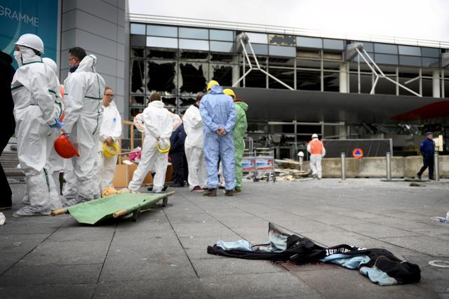 Rescuers attend a ceremony outside the terminal at Brussels airport following bomb attacks in Brussels. (Reuterrs Photo) Rescuers attend a ceremony outside the terminal at Brussels airport following bomb attacks in Brussels. (Reuterrs Photo)