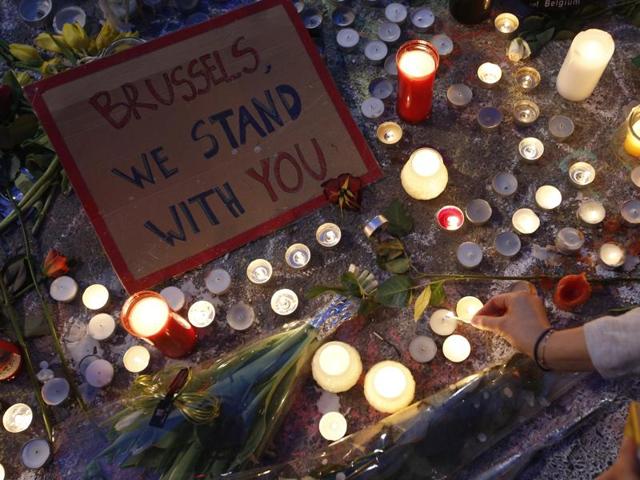 A woman lights a candle among the tributes to the victims of the recent attacks in Brussels, placed in Place de la Bourse in the centre of Brussels, Thursday, March, 24, 2016. (AP Photo) A woman lights a candle among the tributes to the victims of the recent attacks in Brussels, placed in Place de la Bourse in the centre of Brussels, Thursday, March, 24, 2016. (AP Photo)