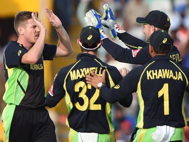 Australia's James Faulkner celebrates with teammates after bowling out Pakistan's Sharjeel Khan.(AFP Photo)