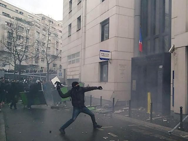 An image grab from a video taken on Friday shows a young people throwing projectiles against the police station of Paris 19th arrondissement, in a sign of protest against alleged police violence on a student on Friday during a demonstration of youths against the French labour law reform. (AFP) An image grab from a video taken on Friday shows a young people throwing projectiles against the police station of Paris 19th arrondissement, in a sign of protest against alleged police violence on a student on Friday during a demonstration of youths against the French labour law reform. (AFP)