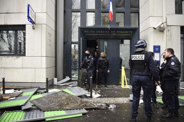 Cops stand outside a damaged police station of Paris 19th arrondissement. (AFP) Cops stand outside a damaged police station of Paris 19th arrondissement. (AFP)