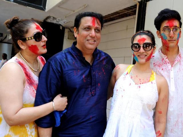 Govinda poses with his wife Sunita Ahuja, daughter Narmada Ahuja and son Yashvardan Ahuja during Holi. (AFP)