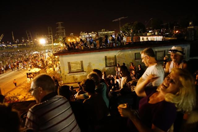 People watch the Rolling Stones concert on the terraces of the houses near the venue in Havana, Cuba, Friday March 25, 2016. (AP Photo) People watch the Rolling Stones concert on the terraces of the houses near the venue in Havana, Cuba, Friday March 25, 2016. (AP Photo)