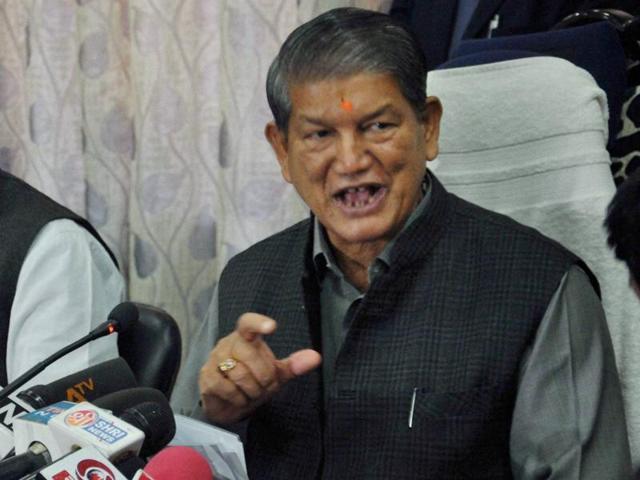 Uttarakhand chief minister Harish Rawat with health minister Surendra Singh Negi during a press conference in Dehradun.(PTI)