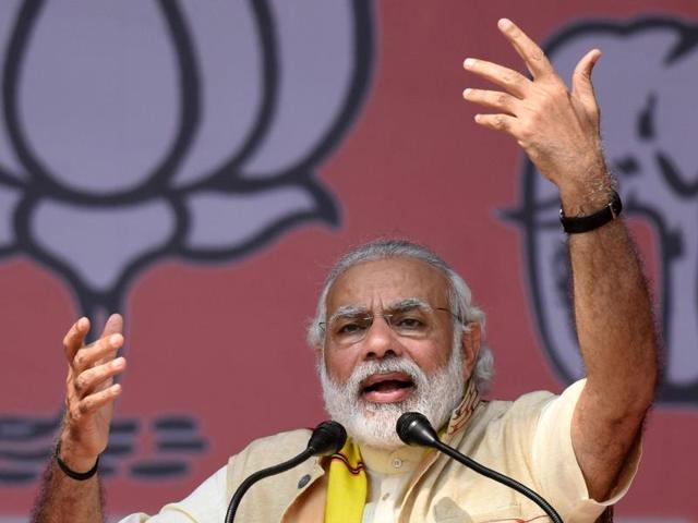 Prime Minister Narendra Modi takes a traditional Assamese mask from BJP chief ministerial candidate Sarbananda Sonwal at an election rally at Majuli, Assam, on Saturday. (AFP photo) Prime Minister Narendra Modi takes a traditional Assamese mask from BJP chief ministerial candidate Sarbananda Sonwal at an election rally at Majuli, Assam, on Saturday. (AFP photo)