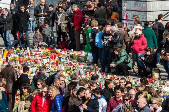 People gather around floral tributes at a memorial site at the Place de la Bourse in Brussels, Saturday, March 26, 2016. (AP Photo) People gather around floral tributes at a memorial site at the Place de la Bourse in Brussels, Saturday, March 26, 2016. (AP Photo)