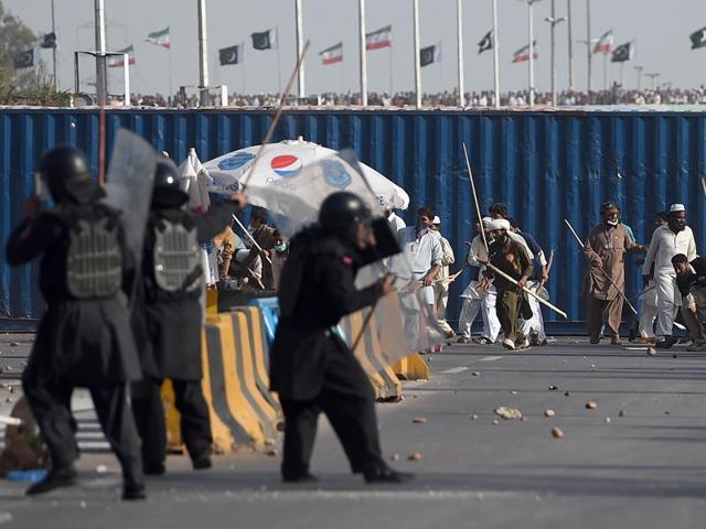 Pakistani protesters clash with police near the parliament building in Islamabad. (AP Photo) Pakistani protesters clash with police near the parliament building in Islamabad. (AP Photo)