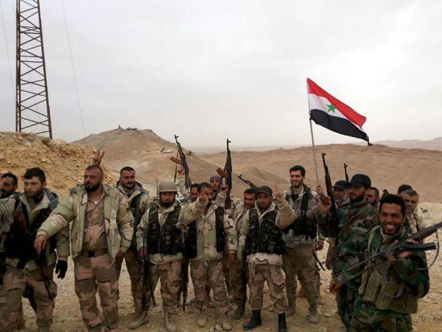 Troops loyal to Syrian President Bashar al-Assad celebrate in Palmyra. State media has reported that the army is in full control of the desert city, which has been under the control of Islamic State since last year. (REUTERS) Troops loyal to Syrian President Bashar al-Assad celebrate in Palmyra. State media has reported that the army is in full control of the desert city, which has been under the control of Islamic State since last year. (REUTERS)