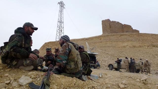 Syrian government forces rest next to the Palmyra citadel during an operation to retake the historic city from Islamic State. (AFP Photo) Syrian government forces rest next to the Palmyra citadel during an operation to retake the historic city from Islamic State. (AFP Photo)