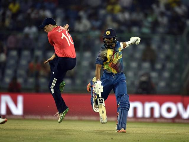 England`s Eoin Morgan jumps to avoid getting hit by the ball as Dinesh Chandimal makes his ground. (Sanjeev Verma/HT Photo) 