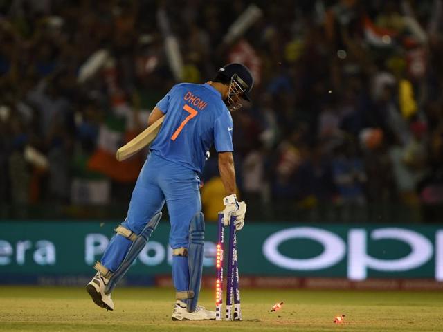 Mahendra Singh Dhoni with his customary habit of collecting the stumps after the win. (AFP) 