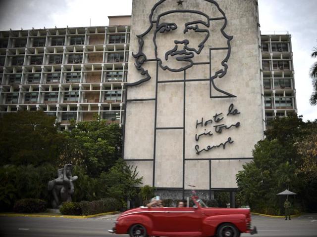 A vintage car drives past a sign at Revolution square in Havana, Cuba on March 19, 2016. (AFP Photo) A vintage car drives past a sign at Revolution square in Havana, Cuba on March 19, 2016. (AFP Photo)