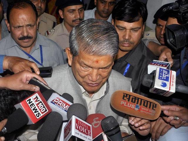 Uttarakhand chief minister Harish Rawat addresses the media outside the state assembly in Dehradun on Saturday, a day before the Centre declared President’s Rule in the state.(PTI photo)