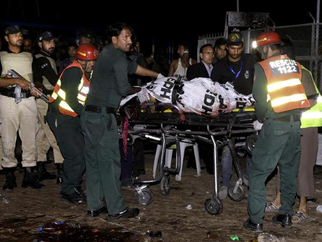 Pakistani rescue workers remove a dead body from the site of bomb explosion in a park in Lahore, Pakistan. (AP Photo) Pakistani rescue workers remove a dead body from the site of bomb explosion in a park in Lahore, Pakistan. (AP Photo)