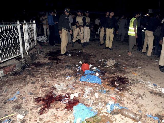 Pakistani emergency workers and police officers gather at a bomb blast site in Lahore. (AFP Photo) Pakistani emergency workers and police officers gather at a bomb blast site in Lahore. (AFP Photo)