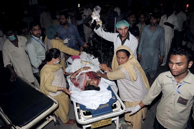 Relatives and emergency workers carry an injured woman to the hospital in Lahore. (AFP Photo) Relatives and emergency workers carry an injured woman to the hospital in Lahore. (AFP Photo)