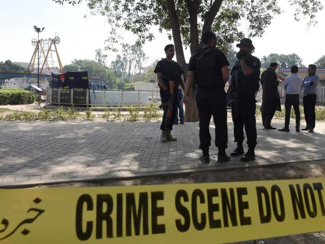 Pakistani police commandos stand guard at the suicide blast site in Lahore. (AFP Photo) Pakistani police commandos stand guard at the suicide blast site in Lahore. (AFP Photo)
