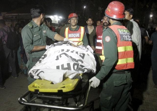 Rescue workers move a body from the site of a blast outside a public park in Lahore. (REUTERS) Rescue workers move a body from the site of a blast outside a public park in Lahore. (REUTERS)