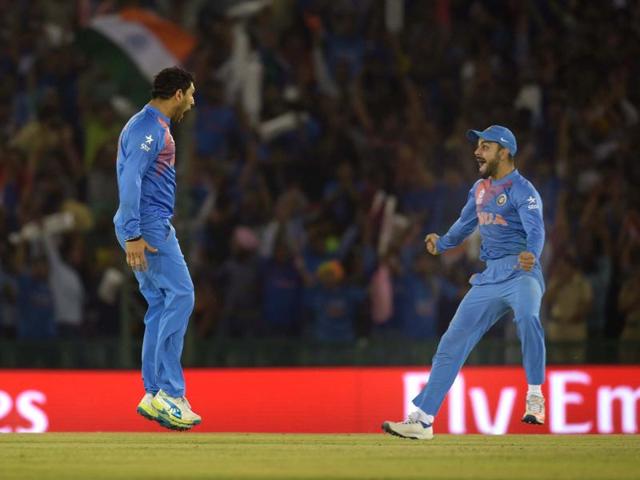 Yuvraj Singh and Virat Kohali celebrate the dismissal of Australian captain Steve Smith. (Ravi Kumar/HT Photo) 