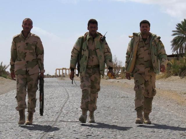Syrian pro-government forces walk on a street in the ancient city of Palmyra. (AFP Photo) Syrian pro-government forces walk on a street in the ancient city of Palmyra. (AFP Photo)