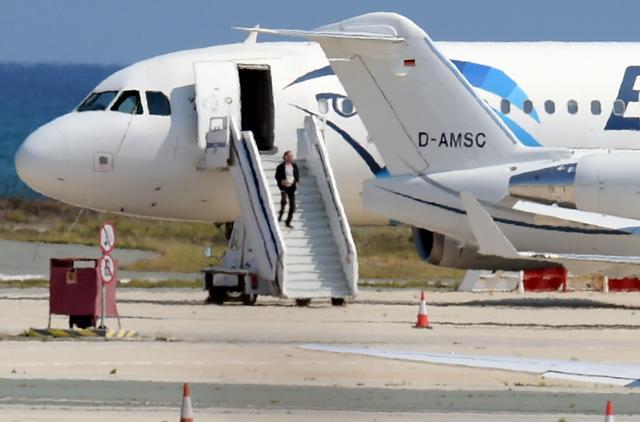A man believed to be the hijacker of the EgyptAir Airbus A-320, which was diverted to Cyprus, leaves the plane before surrendering to security forces after a six-hour standoff on the tarmac at Larnaca airport's largely disused old terminal. (AFP) A man believed to be the hijacker of the EgyptAir Airbus A-320, which was diverted to Cyprus, leaves the plane before surrendering to security forces after a six-hour standoff on the tarmac at Larnaca airport's largely disused old terminal. (AFP)