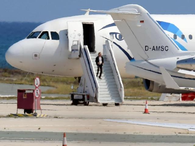 Passengers on the hijacked EgyptAir Airbus A-320 run on the tarmac after leaving the plane. (AFP) Passengers on the hijacked EgyptAir Airbus A-320 run on the tarmac after leaving the plane. (AFP)