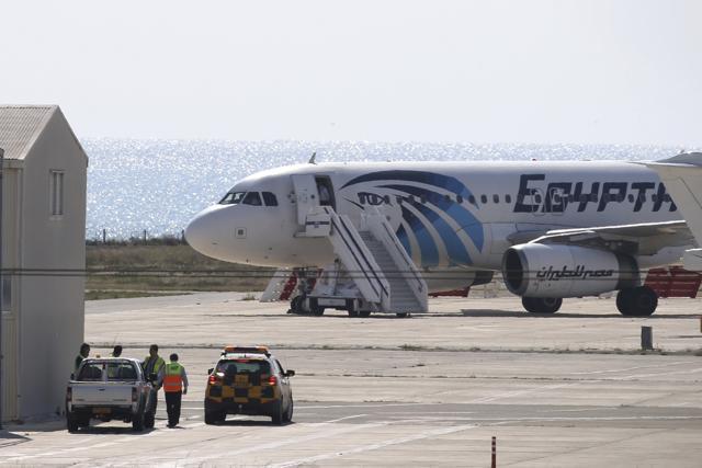 A crew member stands by the door of a hijacked EgyptAir aircraft after landing at Larnaca Airport in Cyprus Tuesday, March 29, 2016. (AP)